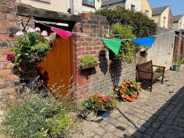 Neighbours in Litherland transform their overgrown alleyway into an amazing community garden