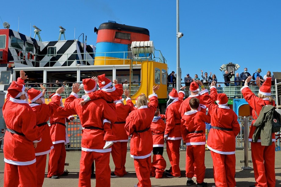 City Santas take Ferry across the Mersey to mark countdown to Liverpool Santa Dash