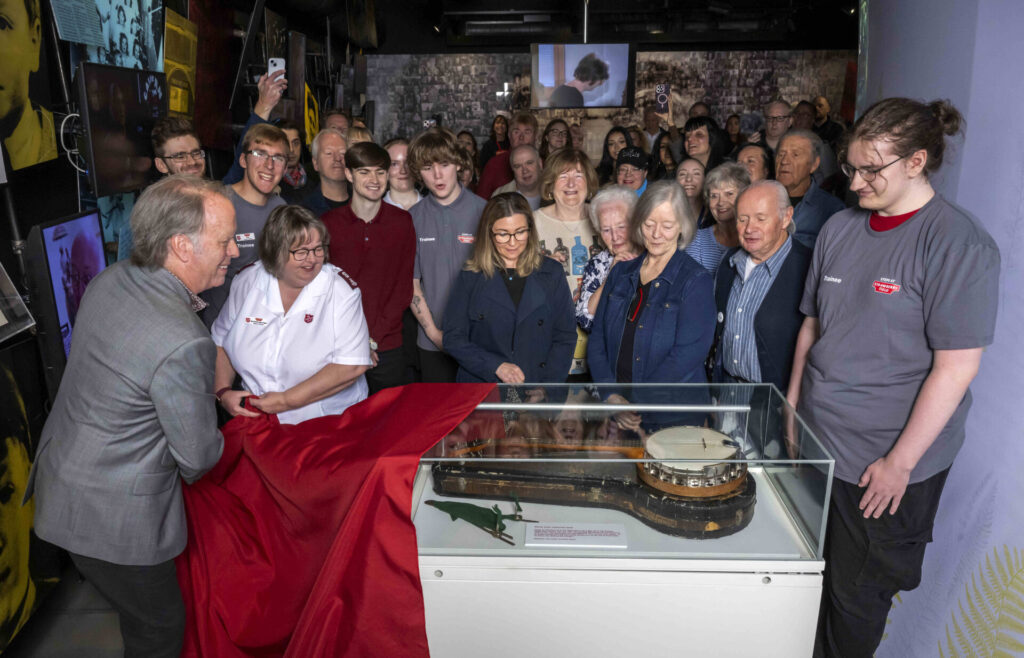 Quarrymen Banjo once played by John Lennon unveiled at Strawberry Field to mark legend’s 85th birthday